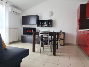 a kitchen with a table and chairs in a room at La casa di Laura in Seregno