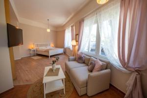 a living room with a couch and a table at Landhaus Appartements Gretl by S4Y in Krumpendorf am Wörthersee