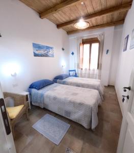 a bedroom with two beds and a window at Apartment Conchiglie 2 in Cala Gonone