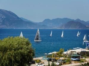 a group of sailboats in the water on a beach at Room in Studio - Independent room for 2 people in Patra