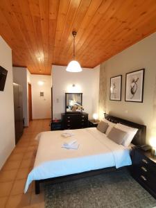 a bedroom with a large bed with a wooden ceiling at Lilea's Castle in Lílaia