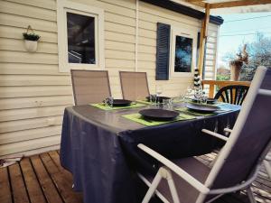 a table with a blue table cloth on a patio at Mobil-Home en camping**** in Vic-la-Gardiole