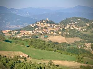 a town on top of a hill with trees at Appartamento La Piazza in Montese