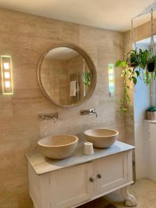 two sinks on a counter in a bathroom with a mirror at The Olive Tree in Begovići