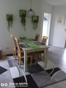 a dining room with a table and chairs at Gemütliche Dachgeschosswohnung in Melle