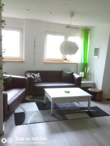 a living room with a couch and a coffee table at Gemütliche Dachgeschosswohnung in Melle