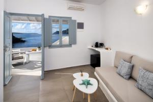 a living room with a couch and a table at Lava Stone in Oia