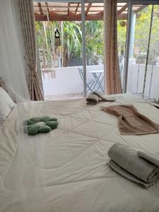 a white bed with towels on top of it at Luana Villas in Ban Mo Nae