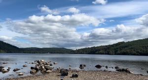 a large body of water with rocks in the water at Eldon Lea in Strathpeffer