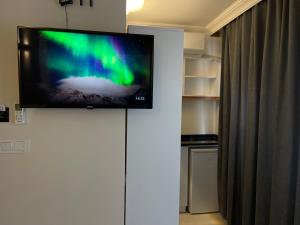 a flat screen tv on top of a white wall at Green Star Pera Hotel in Istanbul