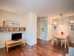 a living room with a table and a dining room at Luxury Suites Collection - Ponchielli 19 in Riccione