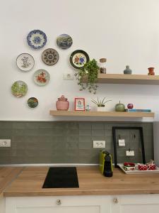 a kitchen counter with plates on the wall at Hey Central Apartment in Timişoara +4 photos