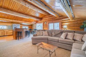 a living room with a couch and a table at Tucked Away Timber Upper Suite in Fairbanks