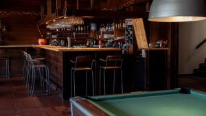 a bar with a pool table and a bar with a bill at Champoussin Lodge in Champoussin