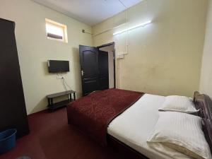a bedroom with a bed and a television in it at Meera stays in Coimbatore