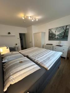 a bedroom with a large bed in a room at TOP-Ferienwohnung bei Berlin, bis 3 Gäste, Terrasse und Garten in Bestensee