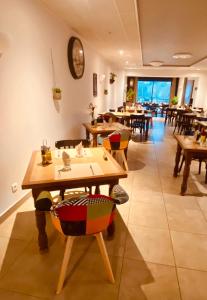 a restaurant with wooden tables and chairs in a room at Restaurant Hôtel du Vercors in Saint-Martin-en-Vercors