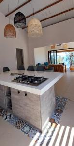 a kitchen with a counter with a stove top at Canari Waterfront Villas in Roches Noires