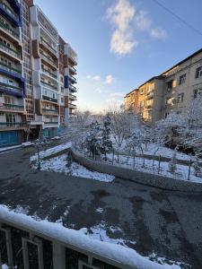 a view of a courtyard with snow covered buildings at New apartment in Yunusobod dist. in Tashkent