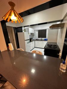 a kitchen with a table and a stove top oven at Home Away Comfort stay in Suva