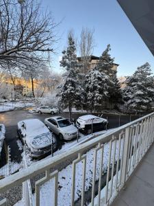 a group of cars parked in a parking lot covered in snow at New apartment in Yunusobod dist. in Tashkent