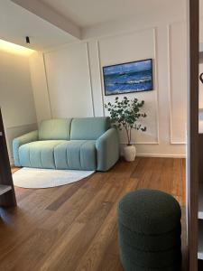 a living room with a blue couch and a chair at Azuma Luxury Home in Bari