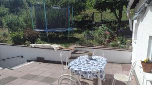 a patio with a table and chairs and a swing at Nice + sunny room, balkony, all facilities... in Trier
