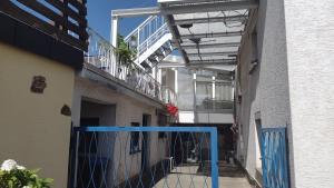 a hallway of a building with a blue fence at Nice + sunny room, balkony, all facilities... in Trier