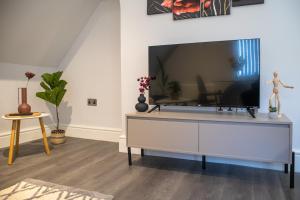 a living room with a large flat screen tv at MSRSH lux 5 in Manchester