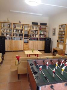 a living room with a table and a room with book shelves at Askalosia villa in Agios Georgios
