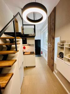 a kitchen with stairs and a large light fixture at City Apartments in Tallinn