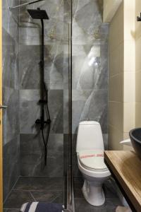 a bathroom with a toilet and a glass shower at Limani Comfort Rooms in Thessaloniki