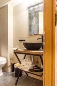 a bathroom with a sink and a toilet at Limani Comfort Rooms in Thessaloniki