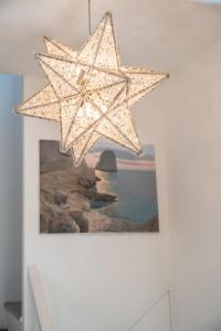 a hanging star chandelier in a room with a picture at Villa Navarra in Praiano