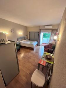 a small room with a bed and a desk and a kitchen at Studio near the beach in Albufeira +28 photos