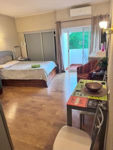 a bedroom with a bed and a living room at Studio near the beach in Albufeira