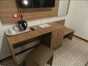 a wooden desk in a room with a tv at SAMIR HOTEL in Alger