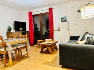 a living room with a couch and a table at Appartement T3 Allemond in Allemont