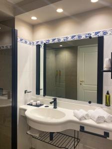 a bathroom with a sink and a mirror at Reggio Calabria Altafiumara Resort & Spa in Villa San Giovanni