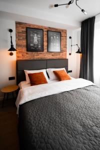 a bedroom with a large bed with a brick wall at MYFREEDOM Апартаменти Братиславська 4 in Kyiv