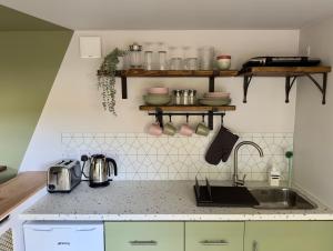 a kitchen with a sink and a counter top at The Snug: Dorset hideaway in Blandford Forum