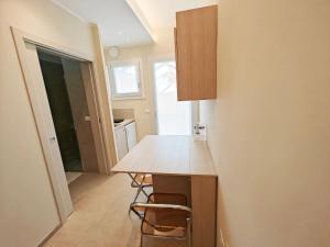 a kitchen with a counter and a table and chairs at A casa di Nina in Leverano