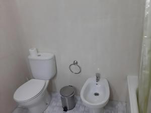 a white bathroom with a toilet and a bidet at Hotel Campestre Chamuiñas in Pontevedra