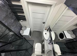 a bathroom with a staircase with a toilet and a door at Eros Gdynia, Śródmieście in Gdynia