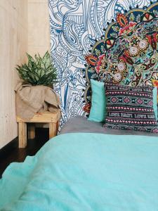 a bedroom with a bed and a colorful wall at Sky Homestay in Da Lat