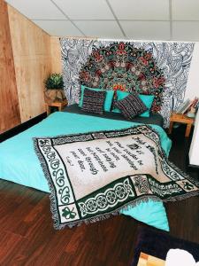 a bedroom with a bed with a large headboard at Sky Homestay in Da Lat