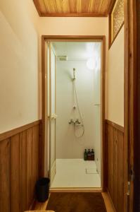 a shower in a bathroom with a glass door at Yanagawa Guest House Horiwari in Yanagawa