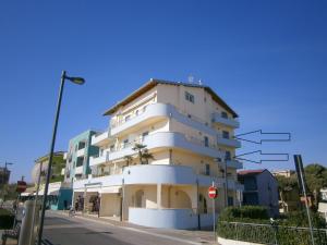 a large white building on the side of a street at Residence Diana Frontemare - Agenzia Cocal in Caorle