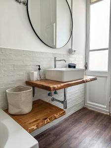 a bathroom with a white sink and a mirror at Giuliana Apartment in Rome