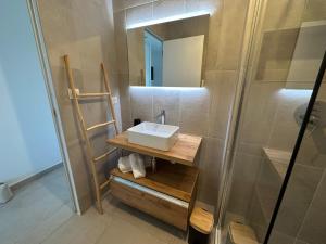 a bathroom with a sink and a shower at T4 Cala Rossa - 3 Ch - Piscine et Plage à pied in Lecci